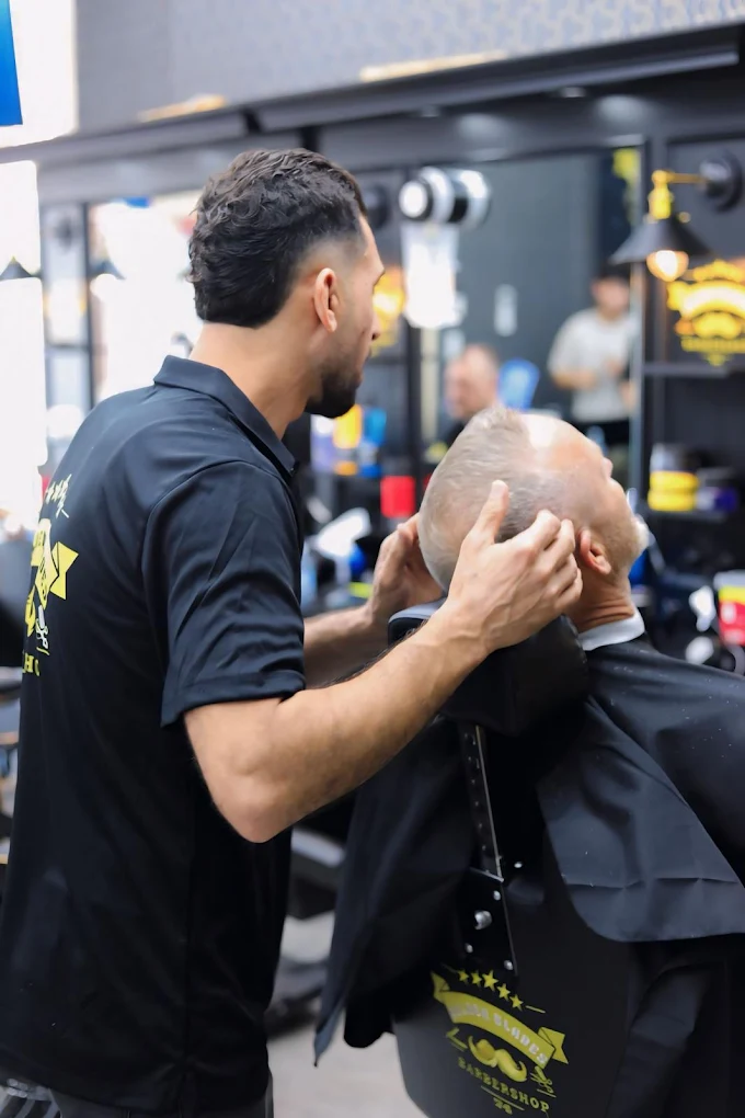 Barber giving a customer the finishing touch at Golden Blades 74, East Toowoomba