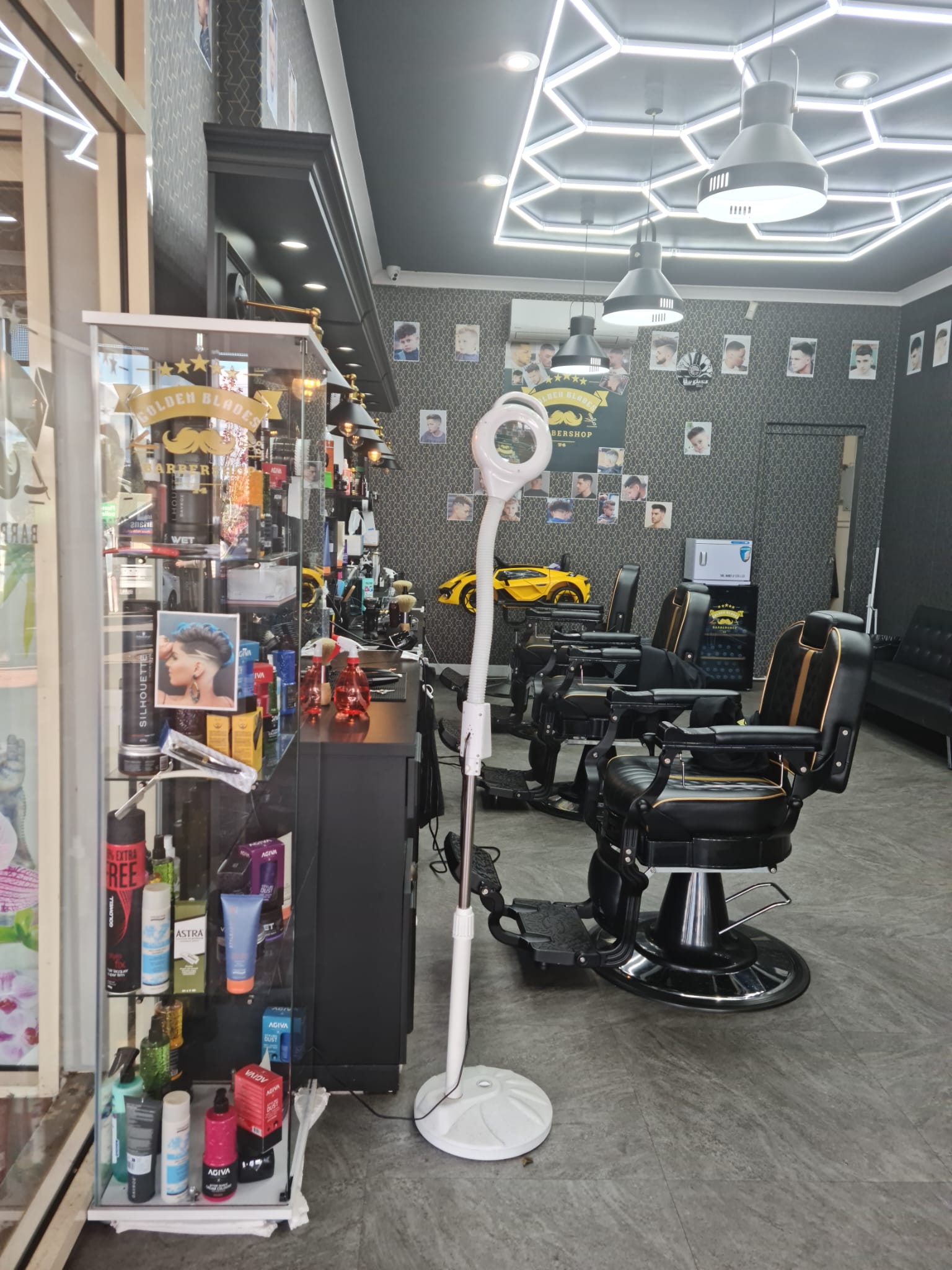 Barber chair, mirrors and product shelves inside Golden Blades 74